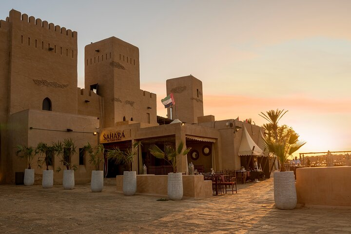 Experience a stunning sunset over the majestic Dubai Desert Royal Fortress where traditional charm meets luxury offering an unforgettable evening filled with cultural delights and culinary indulgence.